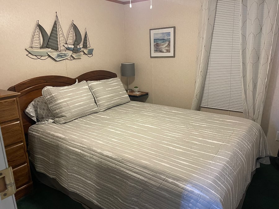 2nd bedroom with queen bed, chest of drawers & closet