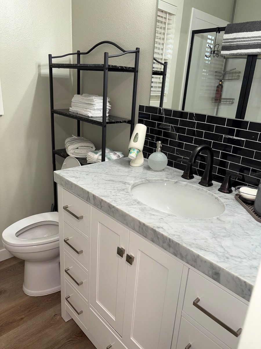 Bathroom has marble countertops, self closing drawers, tile backsplash, vent for steam is required to use with showers.