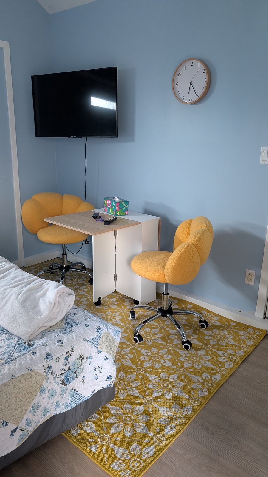 This small table has one side folded up. There is a similar side of the table on the other side so you can fold up and have a bigger space. The two chairs are rolling chairs. Making it easier to shift the table size and move the chairs around. We anticipate this could be used as a desk and as a dining table