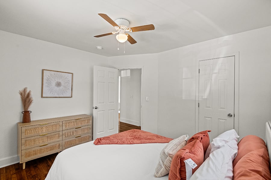 Bedroom with queen bed and closet