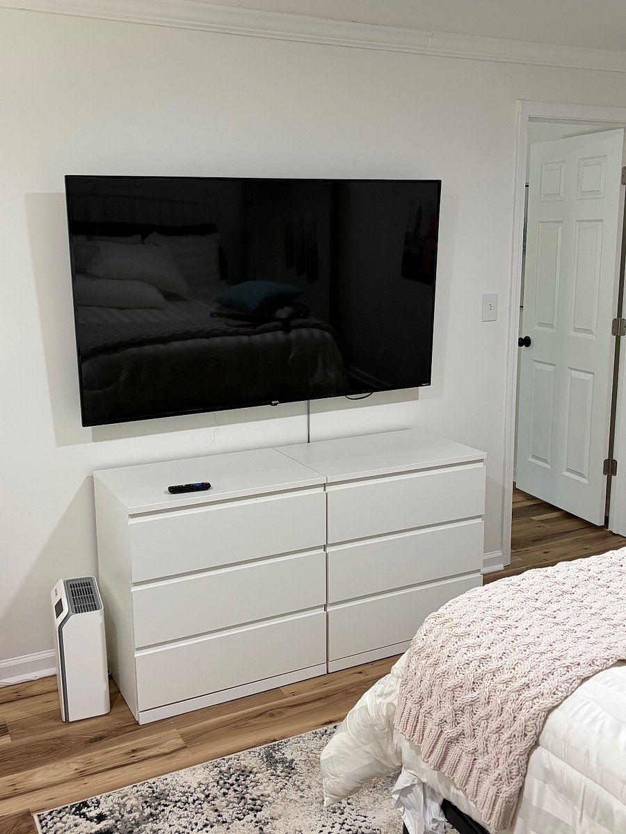 Relax in a comfortable bedroom area featuring a large 55 smart TV perfect for streaming and unwinding after long shift