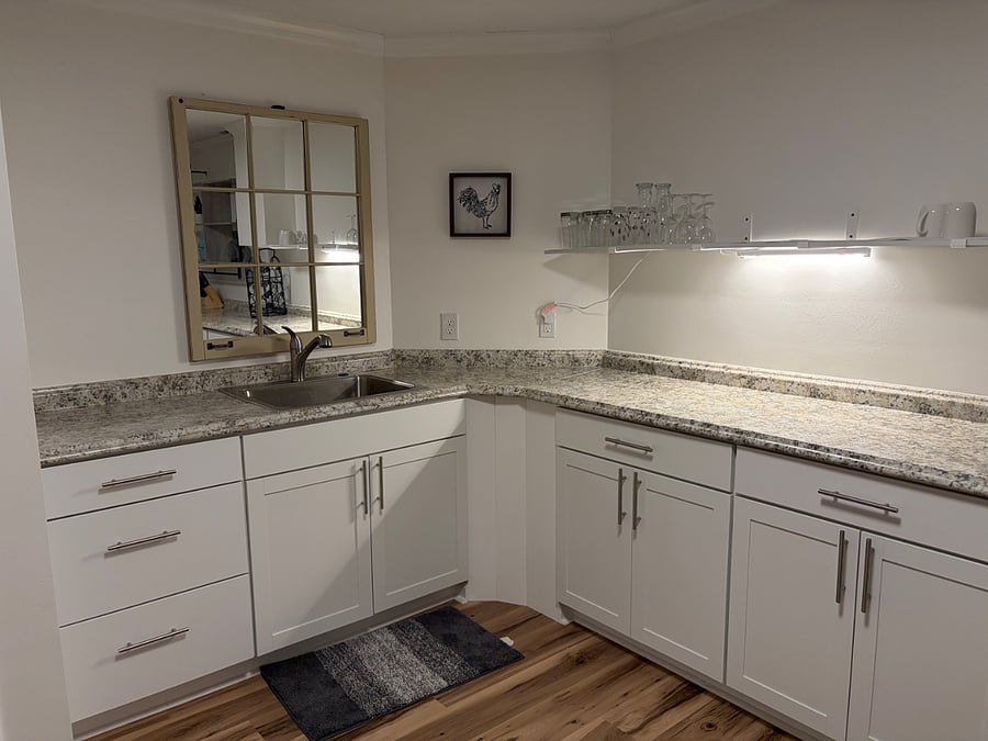 Clean, functional kitchenette with ample counter space