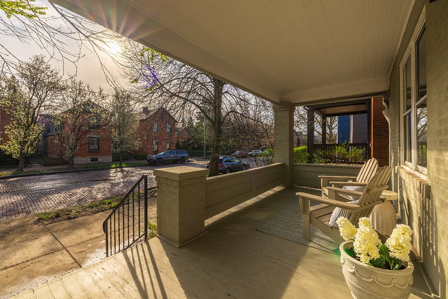 Covered porch looks out on tree-lined road in central German Village