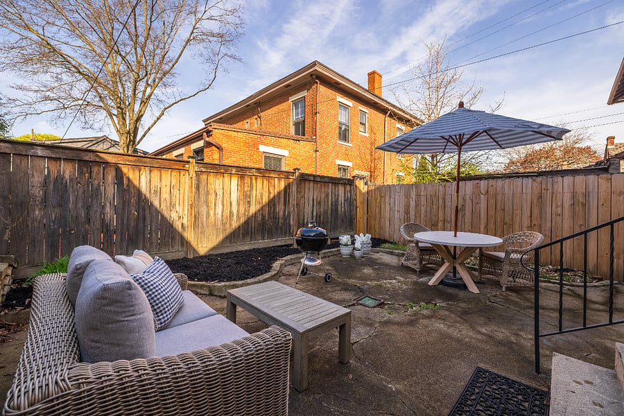 Private, fenced back patio has sun and shade, outdoor eating and seating, and a Weber grill