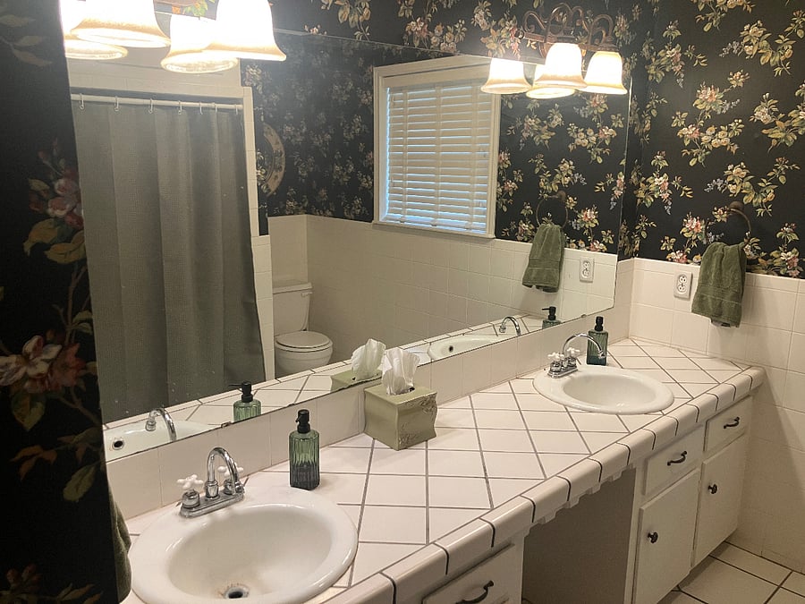 Bathroom #3 shares space with bedroom #3 and bedroom #4. Bath tub with shower and two sinks