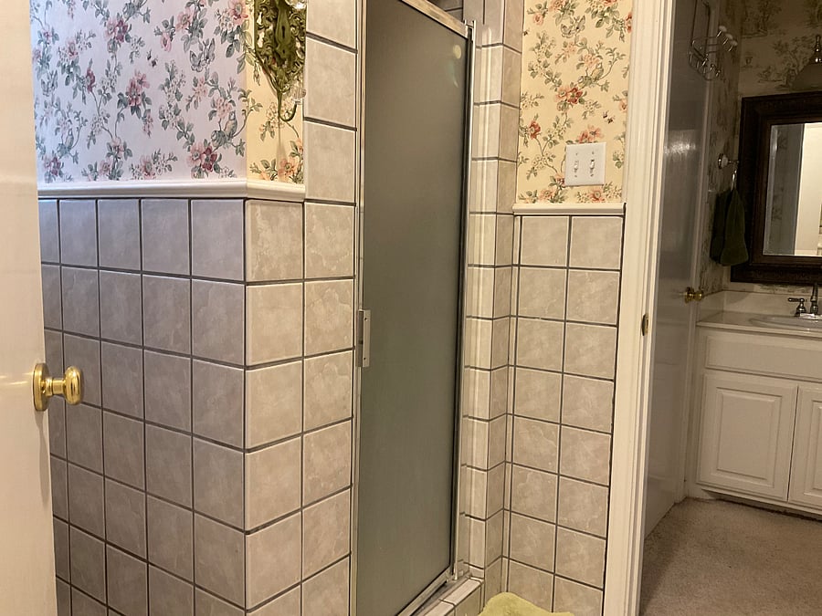 Master bathroom shower and toilet share a separate space between sinks