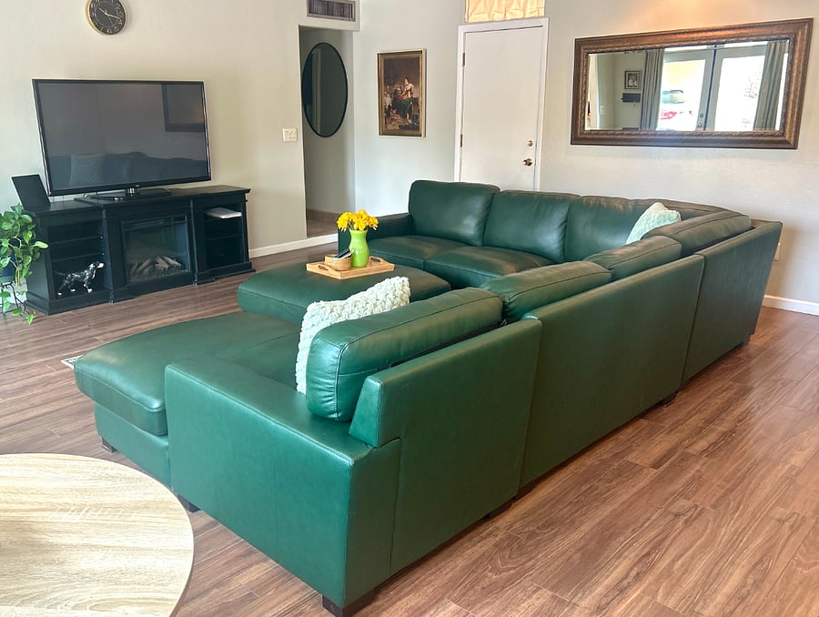 Open living space with TV and seamless flow into dining and kitchen areas