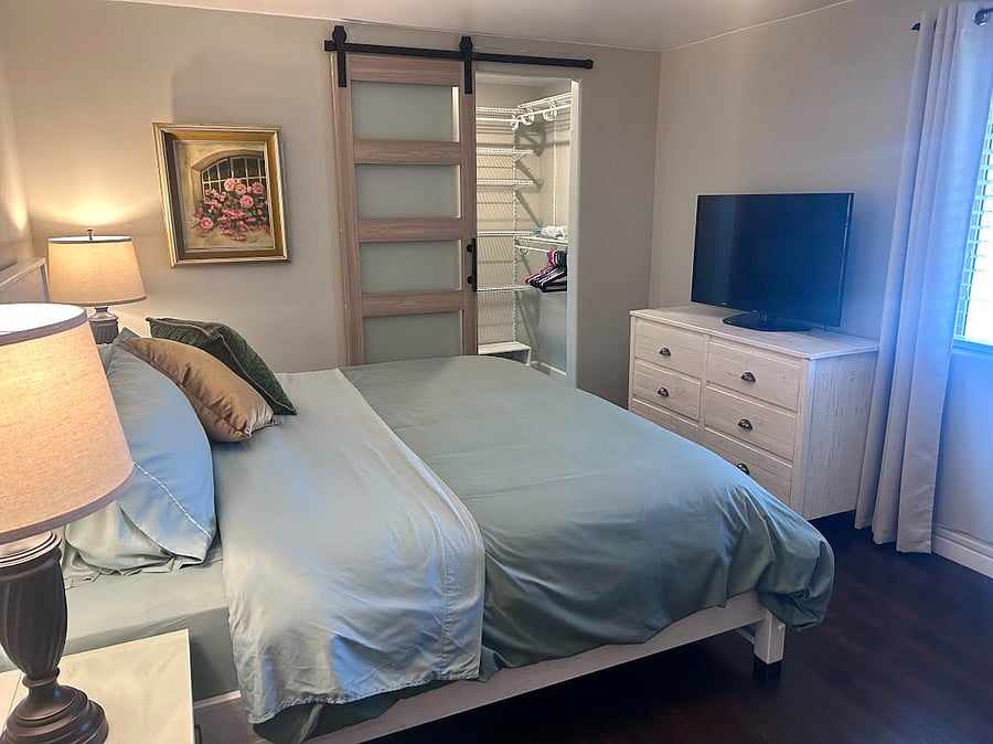Bright and relaxing bedroom with stylish dcor, soft lighting, and a peaceful ambiance