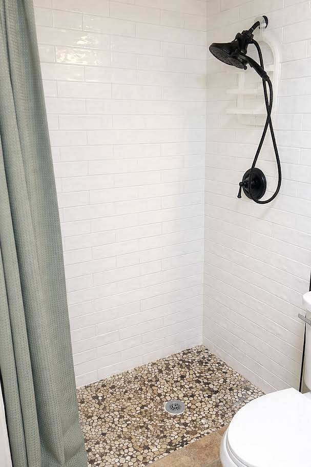Updated bathroom with a walk-in tiled shower and modern fixtures