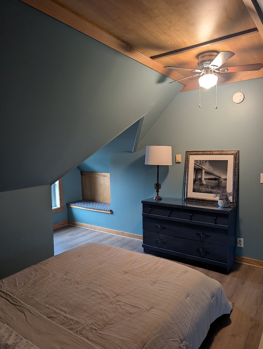 Third-story, queen sized bedroom suite.