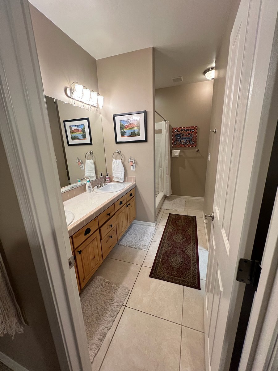 upper level primary suite 2 bath with 2 sinks and shower and walk in closet