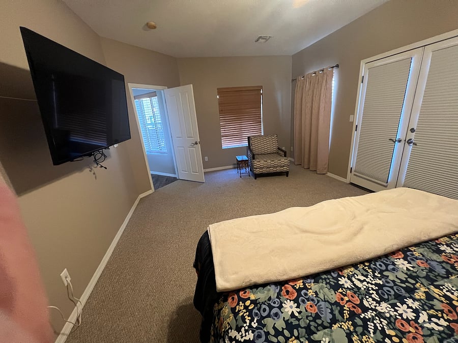upper level primary suite 2 large bedroom with balcony