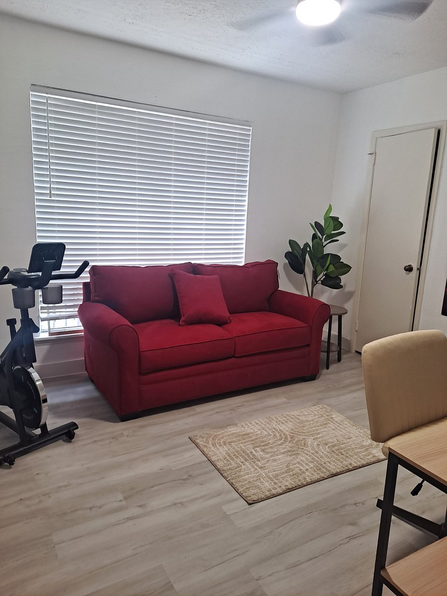 Bonus wellness room with desk, treadmill, and pullout sofa