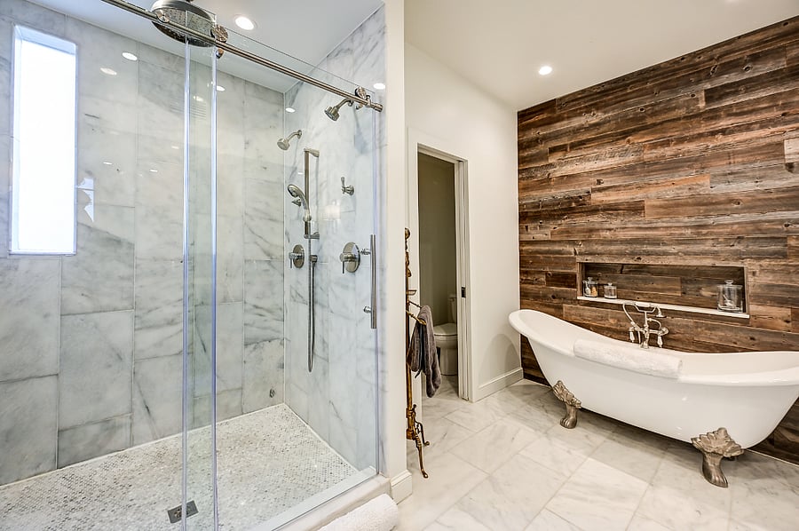 Primary bathroom with dual shower heads and rain shower!  Clawfoot soaker tub for those long days and heated floors for that extra cozy feel.  Bonus - T.V. behind the mirror to watch your favorite show while soaking off the long day.  