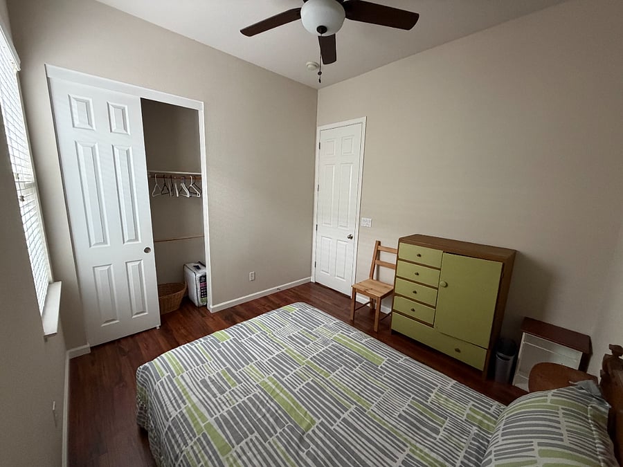 A view of the closet and the green dresser in the second bedroom.