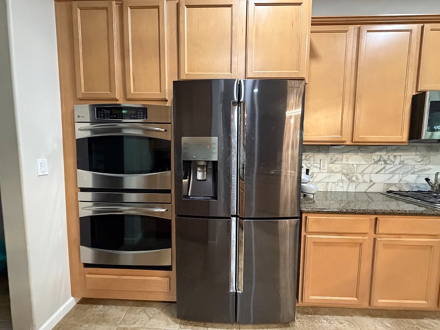Double oven and ample refrigerator. Stove and microwave are on the other side of the counter.