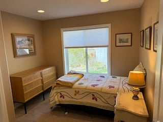 Second bedroom with twin bed, night stand, and chest of drawers.