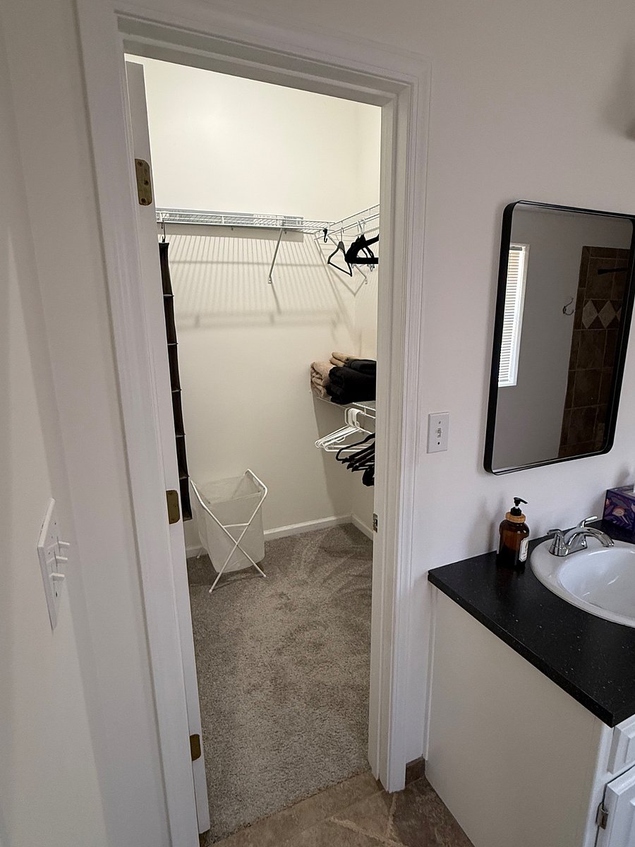 Primary bedroom walk-in closet