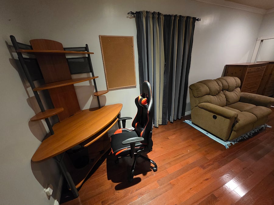 Computer desk and dual seat lazy chair in master bedroom.