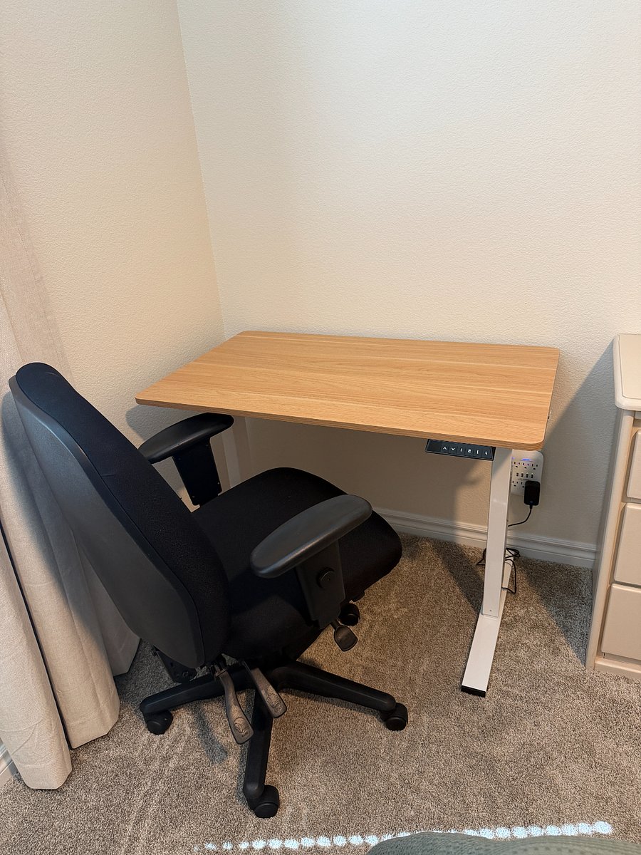 Adjustable desk can be raised to standing position.