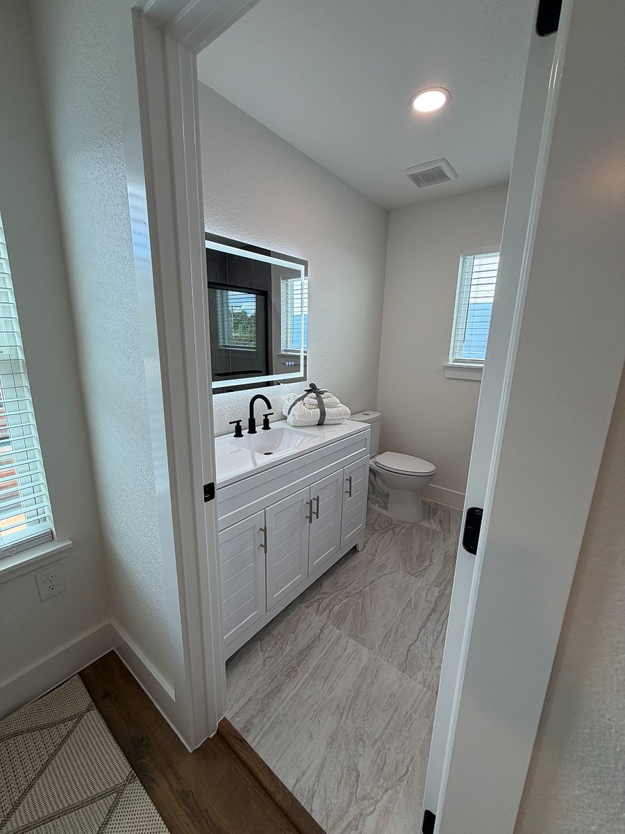 North bedroom bathroom vanity with LED mirror.