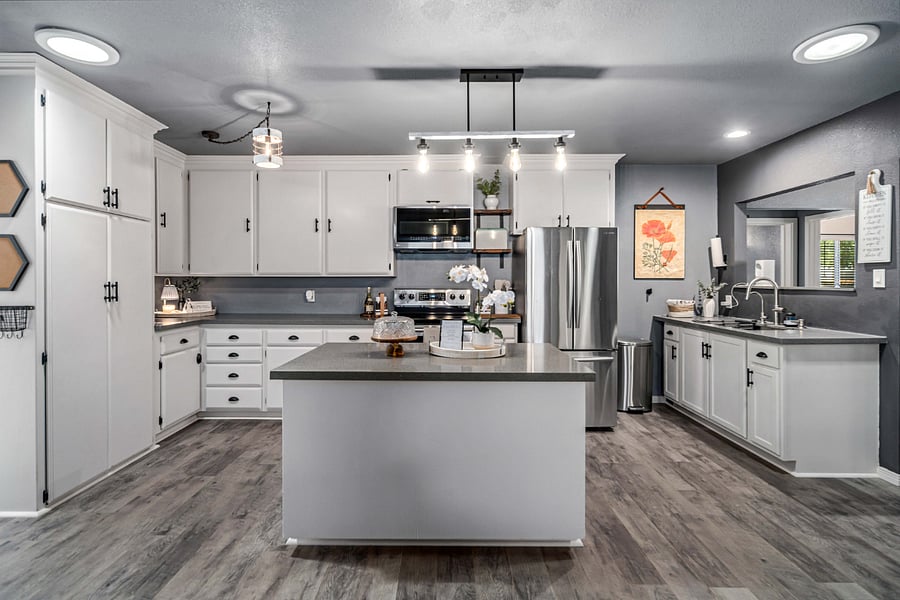 Fully stocked with stainless steel appliances, pots and pans, baking essentials, and a spacious island for meal preparation. 