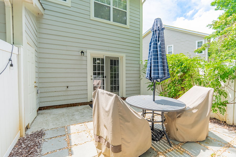 private fenced in patio wtih table and umbrella