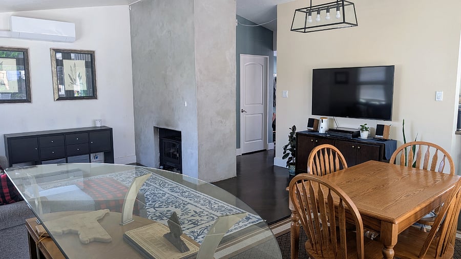 Living room and dining area. Lots of natural light and views of the mountains.