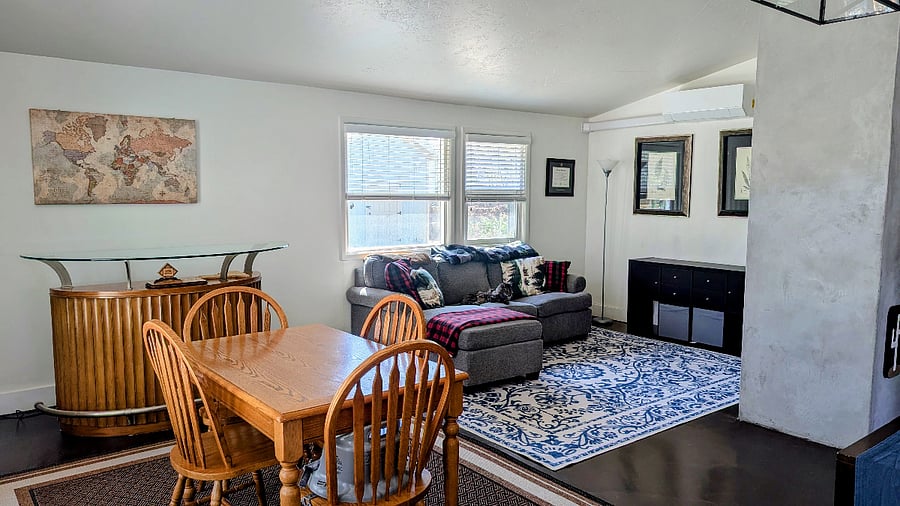 Living room and dining area. Lots of natural light and views of the mountains.