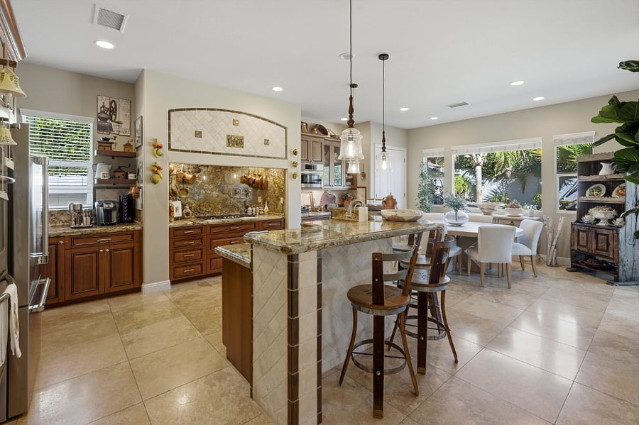 Kitchen with Snack Bar with breakfast/dining area in background.