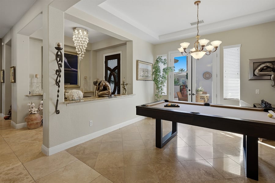Front Door/Foyer to left. Dining Room with pool table.