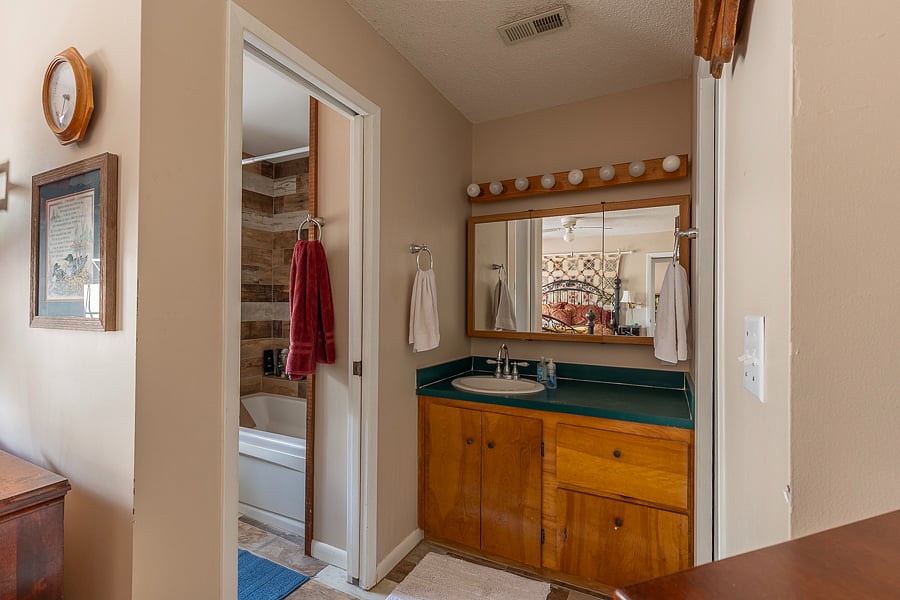 Master bedroom sink with ample storage in drawers. Walk in closet next to sink. 