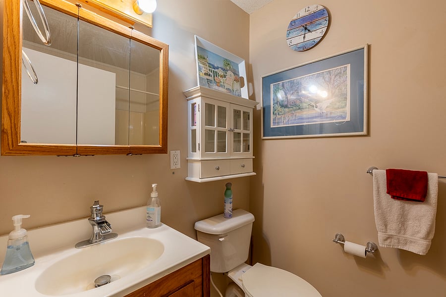 The hall bathroom is a full bath with tub and shower shared by the second and third bedroom guests. 
