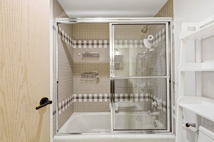 2nd bedroom en suite bathroom with tub and shower. 