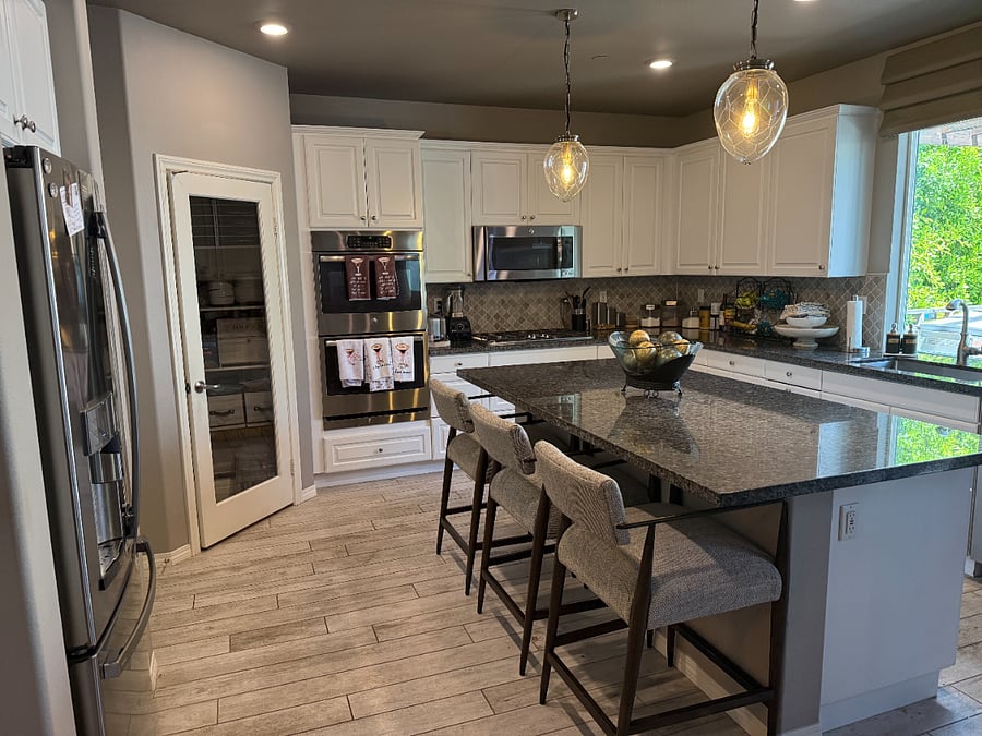 Kitchen with island, pantry, and full appliance set-up - additional fridge/freezer in garage