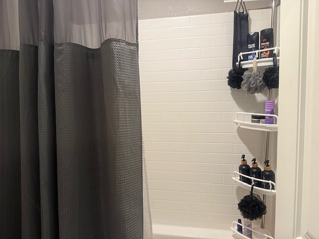 Full-size shower/tub with premium bath amenities