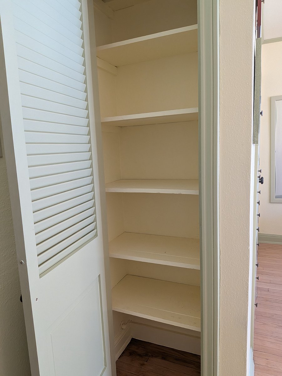 Handy linen closet works well for food, books, shoes, whatever you want to see and get quickly. There's also a deep closet with 2 shelves.