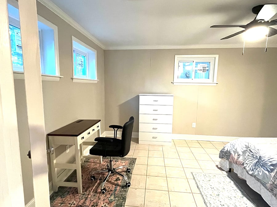 Main bedroom with queen bed, beddings for winter and summer, computer table with chair, dresser, night lamp and bedside table and area rugs