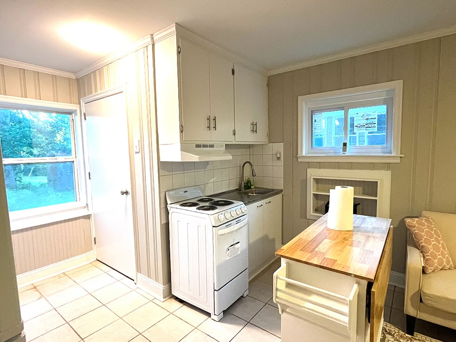 Kitchen area in living room cum kitchen
stove, refrigerator, cabinets with pots dinner ware and silver ware
moveable island with more surface area to work, will adda microwave , toaster and coffee maker