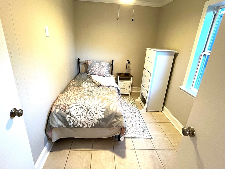 smaller bedroom
twin bed, side table, dresser, lamp and closetBathroom