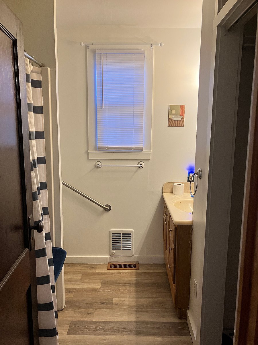 Shower on the left, closet on the right. Grab bar next to the toilet.