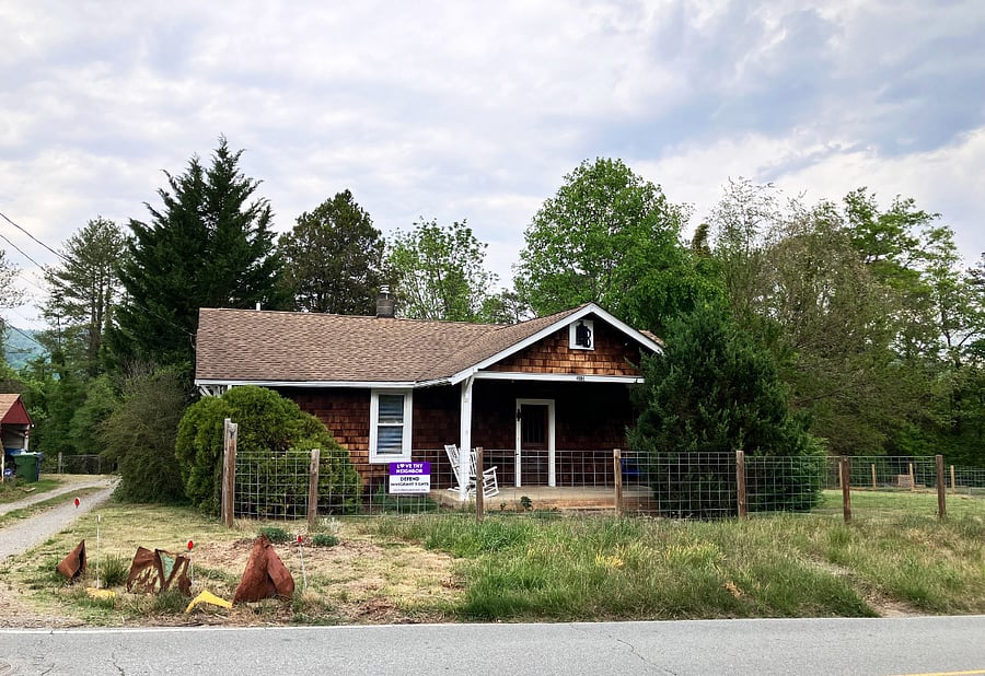 Front of the house, taken from across the street. Cedar shakes on the exterior of the house. The area in the front next to the driveway will be filled with zinnias and cosmos from mid-summer to frost. Vases are in the kitchen!
