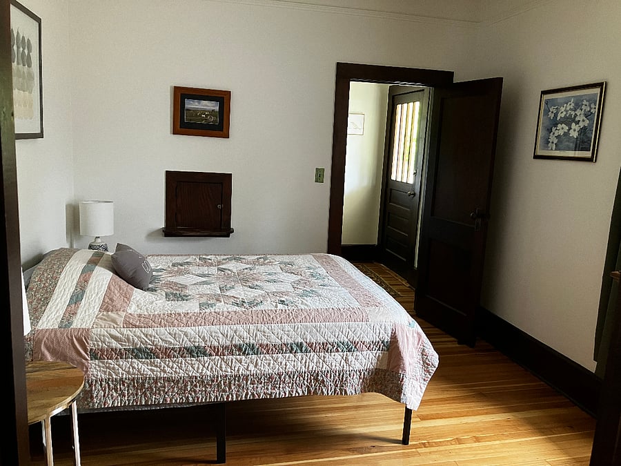 Second bedroom. The front door of the house is visible from this bedroom. That wooden square in the wall? It's a small door that opens to the old-fashioned telephone table in the hall. You can latch the door on the bedroom side. 