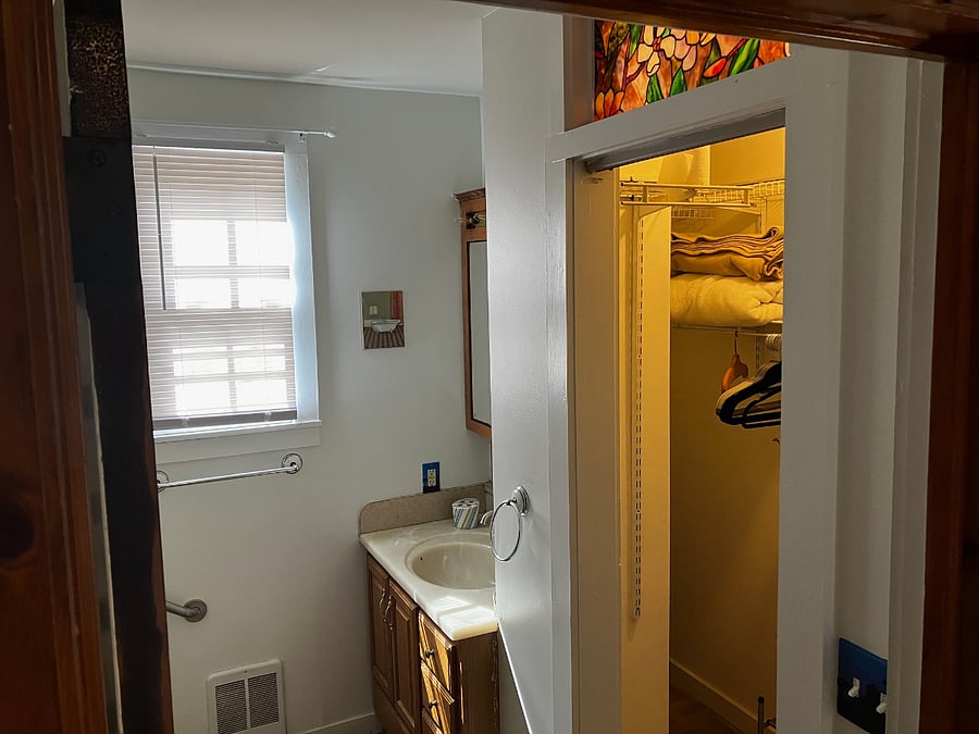 This bathroom has a large closet on the right. 
