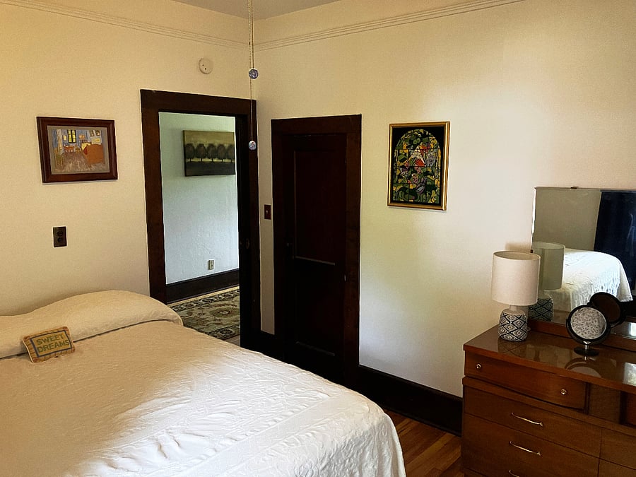 Primary bedroom, looking towards the hallway. Small closet and dresser. 