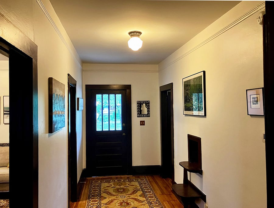 Looking from the hall bathroom (the one with the claw-foot tub) towards the front door. Living and dining rooms on the left, bedrooms on the right.