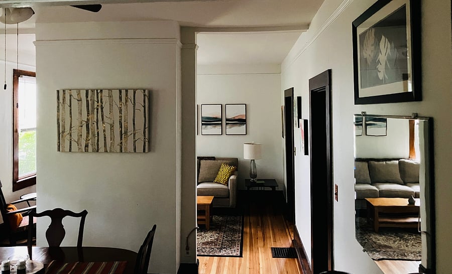 Standing in the kitchen doorway, looking through to dining and living rooms.