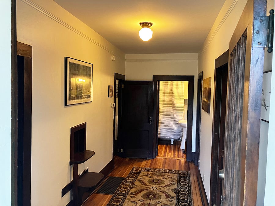 Standing just inside the front door. Living room to the right, bedrooms on the left. 
