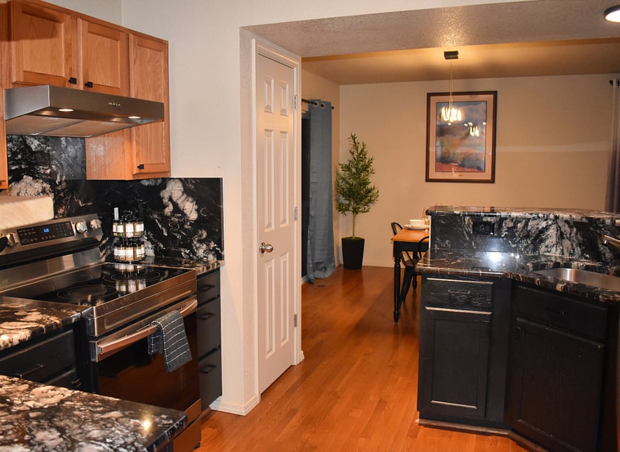Kitchen (view from garage entry) with pantry. 