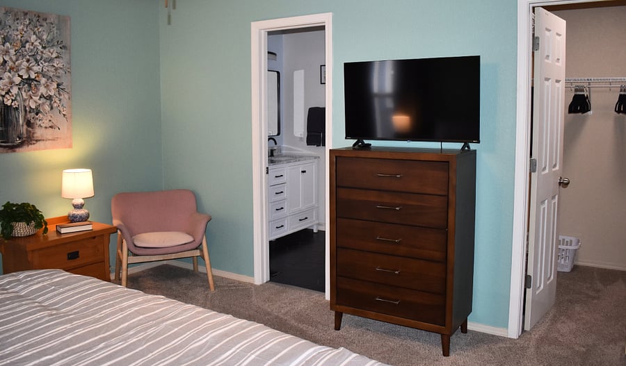 Primary Bedroom with view of ensuite and walk-in closet